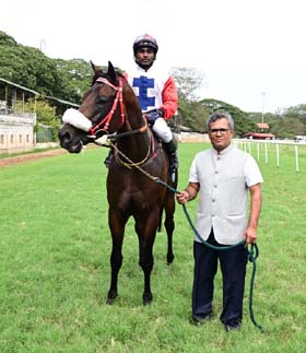 Money Fair (A R Pradeep up) winner of the SRI C.SASHACHALAM MEMORIAL TROPHY, being led in by trainer Prithviraj B on Friday races at Mysore.